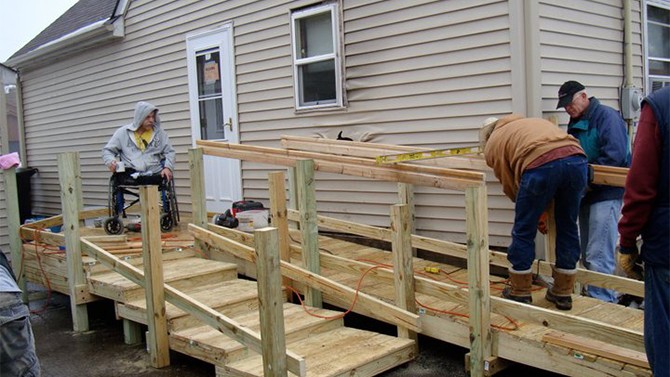 People building a wheelchair ramp.