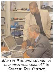 Photo of Marvin Williams demonstrating some AT to Senator Tom Carper